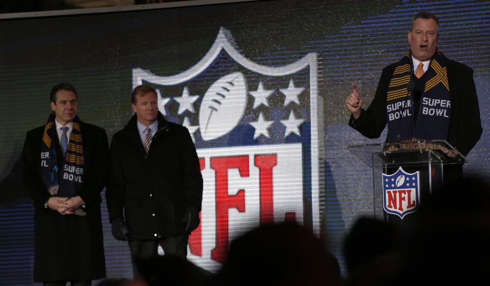 New York City Mayor Bill de Blasio, right, speaks while NFL comissioner Roger Goodell, center, and New York Gov. Andrew Cuomo, left, look on during a ceremony unveiling the Roman numerals for Super Bowl XLVIII on Super Bowl Boulevard Wednesday, Jan. 29, 2014, in New York. The Seattle Seahawks are scheduled to play the Denver Broncos in the NFL Super Bowl XLVIII football game on Sunday, Feb. 2, in East Rutherford, N.J. (AP Photo/Charlie Riedel)