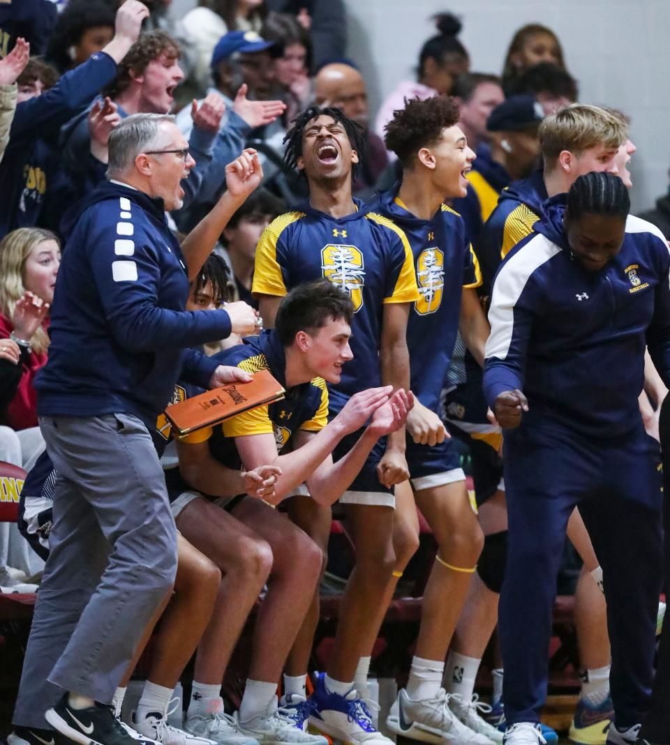 The Sanford bench reacts as the Warriors take the lead against St. Elizabeth in a boys game on Feb. 16. The Warriors passed the ball around for the first 1:04 of the fourth quarter on the way to a 58-51 win.
