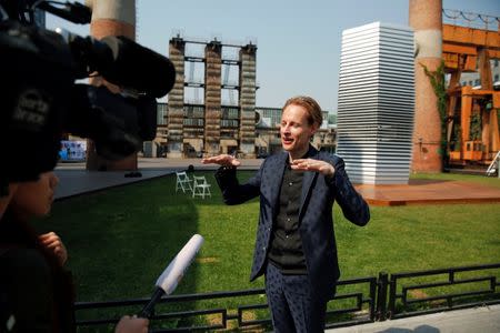 Dutch artist and innovator Daan Roosegaarde talks to reporters in front of the Smog Free Tower, the world's largest smog vacuum cleaner as he presents his The Smog Free Project at D-751 art zone in Beijing September 29, 2016. REUTERS/Damir Sagolj
