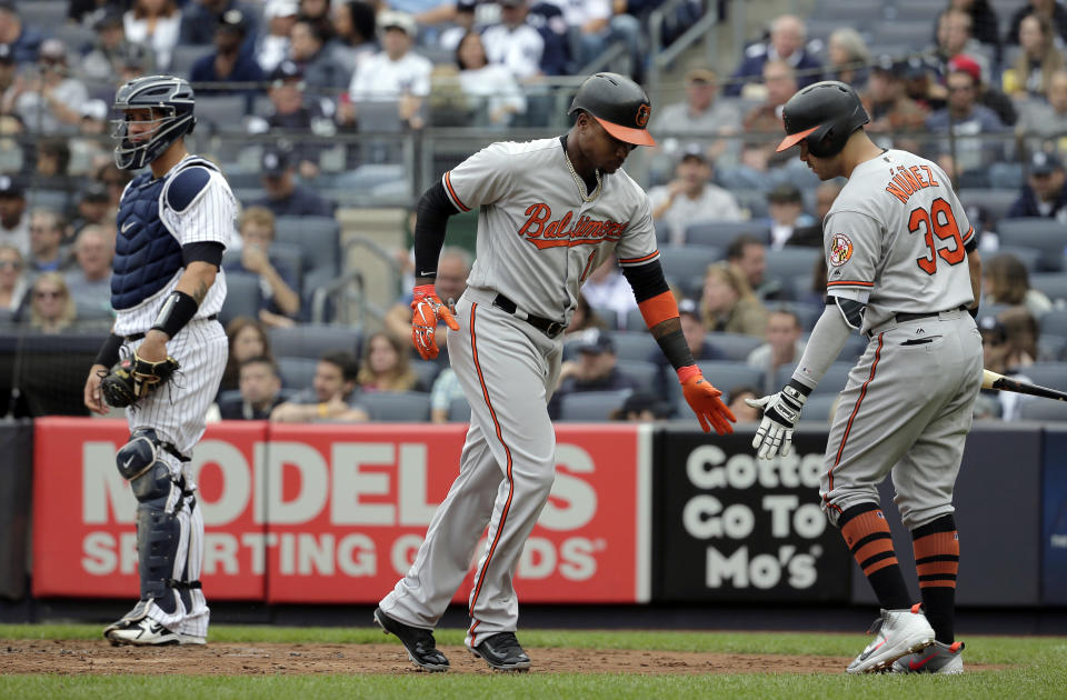 Baltimore Orioles' Tim Beckham, center, celebrates his solo home run with Renato Nunez, right, during the second inning of a baseball game against the New York Yankees at Yankee Stadium, Sunday, Sept. 23, 2018, in New York. (AP Photo/Seth Wenig)