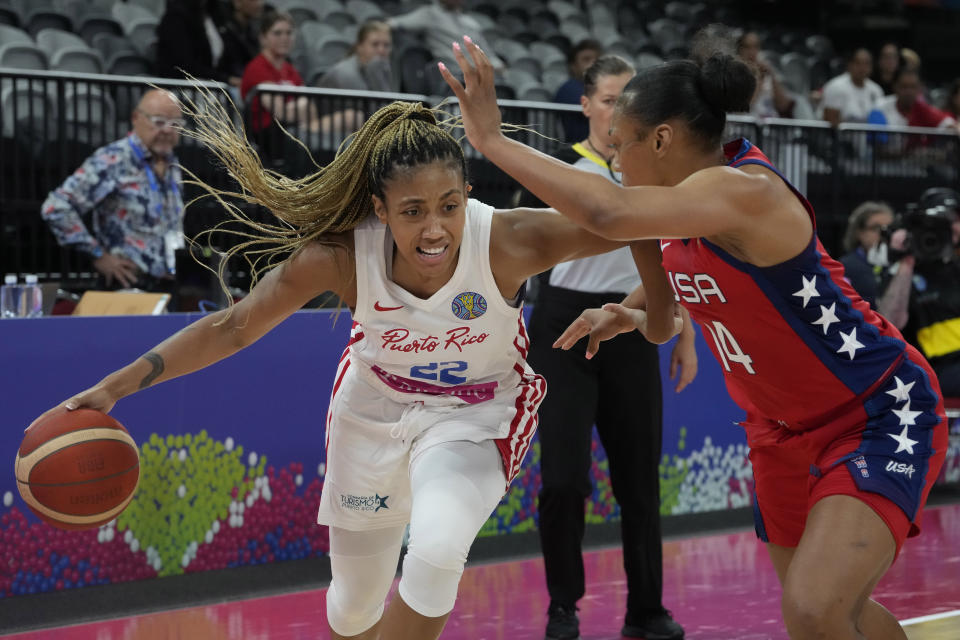 Puerto Rico's Arella Guirantes tries to get the ball past United States' Betnijah Laney at the women's Basketball World Cup in Sydney, Australia, Friday, Sept. 23, 2022. (AP Photo/Mark Baker)