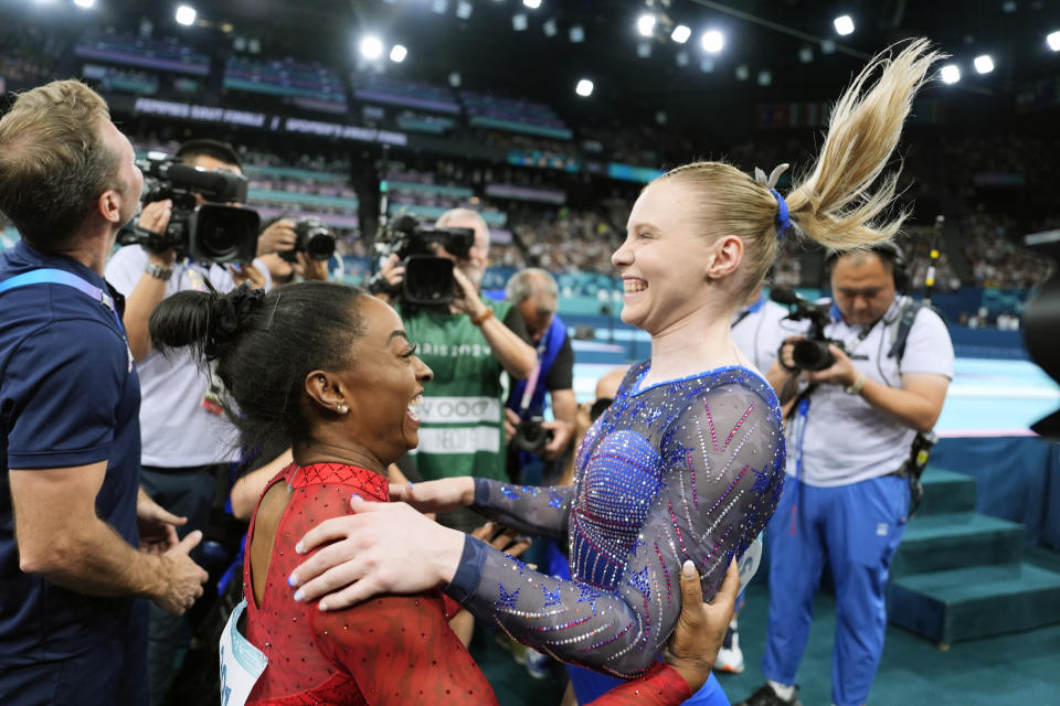 Simone Biles, left, celebrates after winning the gold medal along with bronze medalist Jade Carey, both of the United States, during the women's artistic gymnastics individual vault finals at Bercy Arena at the 2024 Summer Olympics, Saturday, Aug. 3, 2024, in Paris, France. (AP Photo/Charlie Riedel)