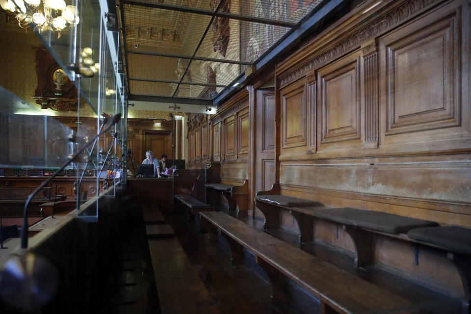 View of the dock in the court room where eight people are going on trial in relation to a bungled terrorist plot against Notre Dame Cathedral, in Paris, Monday, Sept. 23, 2019. The key suspects are two French women who pledged allegiance to the Islamic State group. They allegedly tried to explode a vehicle laden with fuel-doused gas canisters in the shadow of the medieval monument in 2016. (AP Photo/Francois Mori)