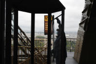 French employee cleans the window during the opening up of the top floor of the Eiffel Tower, in Paris, Wednesday, July 15, 2020. The top floor of Paris' Eiffel Tower reopened today as the 19th century iron monument re-opened its first two floors on June 26 following its longest closure since World War II. (AP Photo/Francois Mori)