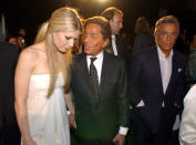 US actress Gwyneth Paltrow, left, arrives holding hands with Italian designer Valentino, center, as Valentino associate Giancarlo Giammetti, right, looks on, for the "Una Notte a Roma" (a night in Rome) televised fashion show, in Rome's historic Piazza Navona Square, Wednesday, June 1, 2005. The show features collections by Armani, Versace, Valentino and Ferre'. (AP Photo/Corrado Giambalvo)