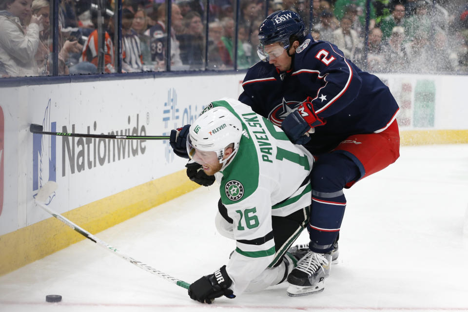 Columbus Blue Jackets' Andrew Peeke, right, pushes Dallas Stars' Joe Pavelski to the ice during the third period of an NHL hockey game Monday, Oct. 25, 2021, in Columbus, Ohio. The Blue Jackets beat the Stars 4-1. (AP Photo/Jay LaPrete)