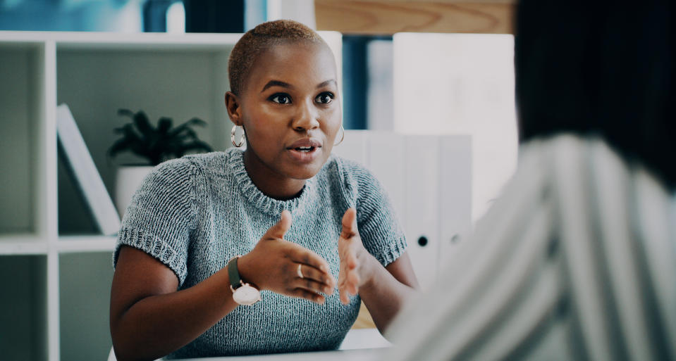 Shot of a young businesswoman having a discussion with a colleague in an office