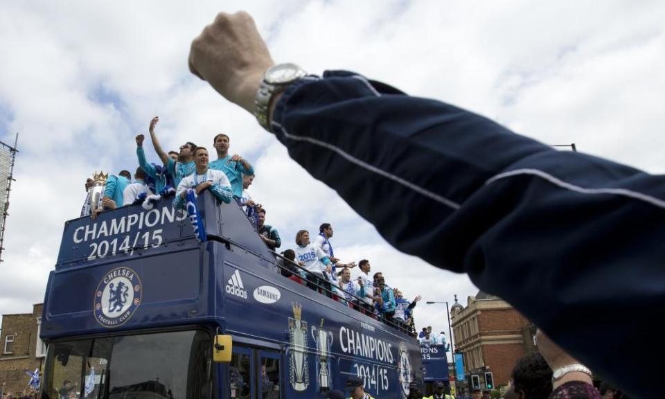 Fans salute the Chelsea team as they parade through the streets after winning the Premier League title for 2014/15 as well as the League Cup.