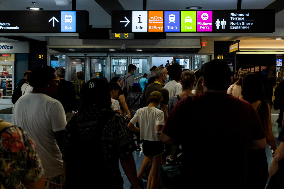 People disembark the Staten Island Ferry at the St. George Terminal, Thursday, Aug. 4, 2022, in the Staten Island borough of New York. (AP Photo/Julia Nikhinson)