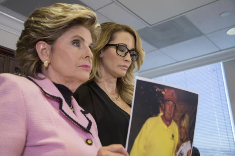 Attorney Gloria Allred holds a photo of Jessica Drake (R) with Donald Trump, taken in 2006 during an event where Drake alleges Trump behaved in a sexually inappropriate way toward her