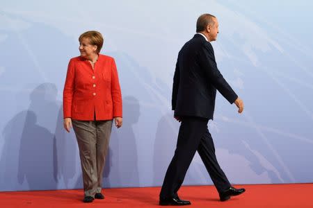FILE PHOTO: German Chancellor Angela Merkel greets Turkey's President Recep Tayyip Erdogan at the beginning of the G20 summit in Hamburg, Germany, July 7, 2017. REUTERS/Bernd Von Jutrczenka/POOL/File Photo