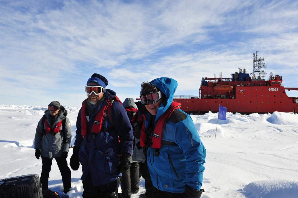 In this photo provided China's official Xinhnua News Agency, the first group of passengers who were aboard the trapped Russian ship MV Akademik Shokalskiy arrive at a safe surface off the Antarctic Thursday, Jan. 2, 2014. A helicopter rescued all 52 passengers from the research ship that has been trapped in Antarctic ice, 1,500 nautical miles south of Hobart, Australia, since Christmas Eve after weather conditions finally cleared enough for the operation Thursday. (AP Photo/Xinhua, Zhang Jiansong) NO SALES
