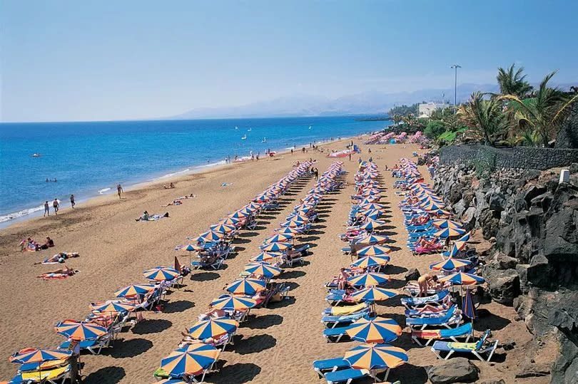 People sunbathing on Playa Blanca in Puerto Del Carmen, Lanzarote