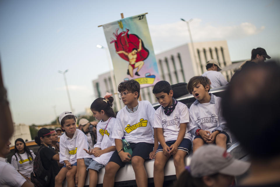 Youths attend a march coined "Culiacan Valiente," or Brave Culiacan, to protest violence and demand safety in Culiacan, Mexico, Sunday, Oct. 27, 2019. Residents are still coming to grips with the worst cartel violence in recent memory, in which 13 people were killed including at least three innocents caught in the crossfire, on Oct. 17, a date now known as “black Thursday.” (AP Photo/Augusto Zurita)