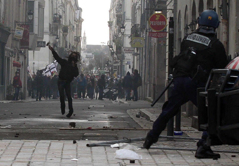 Demonstrators clash against French riot police during a demonstration in Nantes, Saturday, Feb.22, 2014, as part of a protest against a project to build an international airport, in Notre Dame des Landes, near Nantes. The project was decided in 2010 and the international airport should open by 2017. (AP Photo/ Laetitia Notarianni)