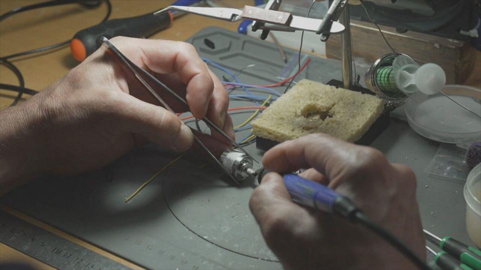 PHOTO: A man works on drone parts in Ukraine. (ABC News)