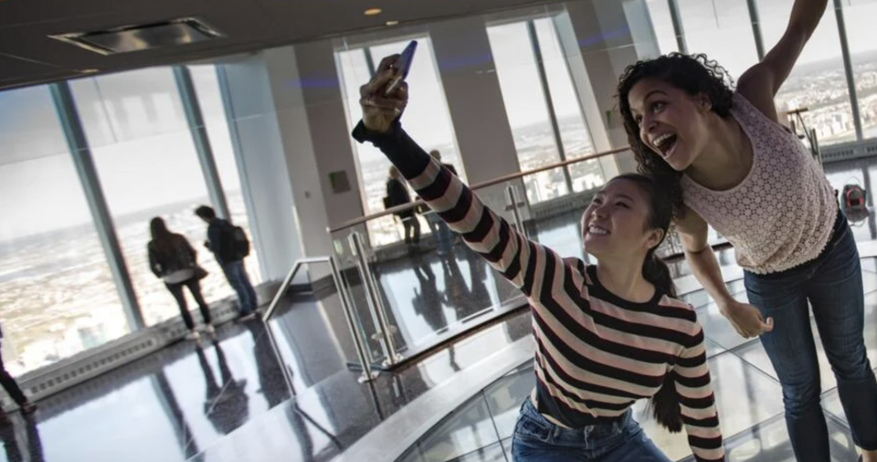 2 girls posing in the One World Observatory. 