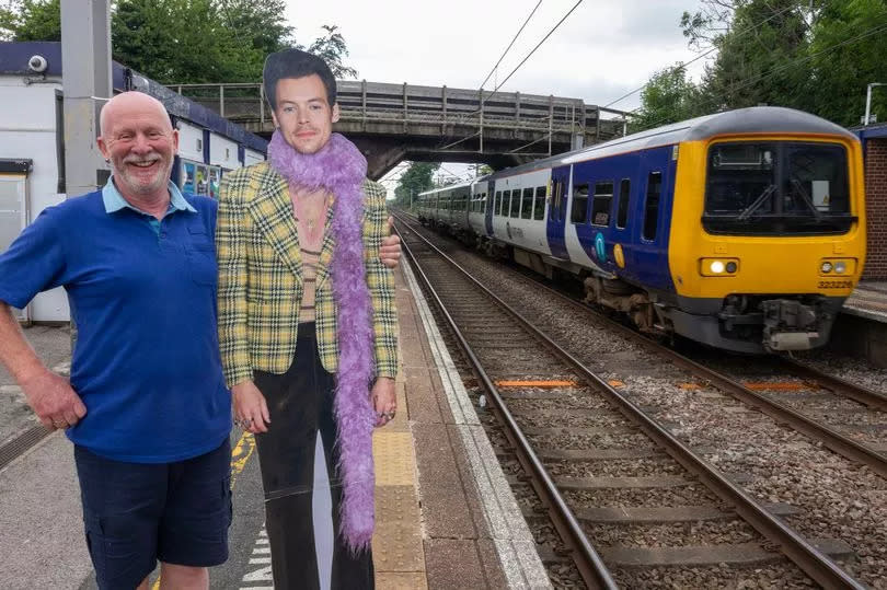 Holmes Chapel train stationmaster Graham Blake with a cardboard cutout of local hero Harry Styles -Credit:Manchester Evening News