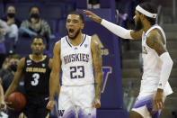 Washington guard Terrell Brown Jr. (23) reacts with guard PJ Fuller, right, after making a basket against Colorado during the second half of an NCAA college basketball game, Thursday, Jan. 27, 2022, in Seattle. Washington won 60-58. (AP Photo/Ted S. Warren)