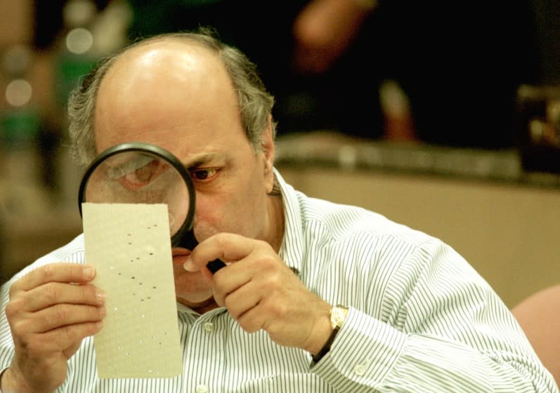 382382 03: (FILE PHOTO) Judge Robert Rosenberg of the Broward County Canvassing Board uses a magnifying glass to examine a dimpled chad on a punch card ballot November 24, 2000 during a vote recount in Fort Lauderdale, Florida. On May 4, 2001 the Florida state legislature overwhelmingly passed a voting reform act designed to eliminate the controversial punch card ballots which were the focal point of recount efforts in the 2000 presidential election. (Photo by Robert King/Newsmakers)