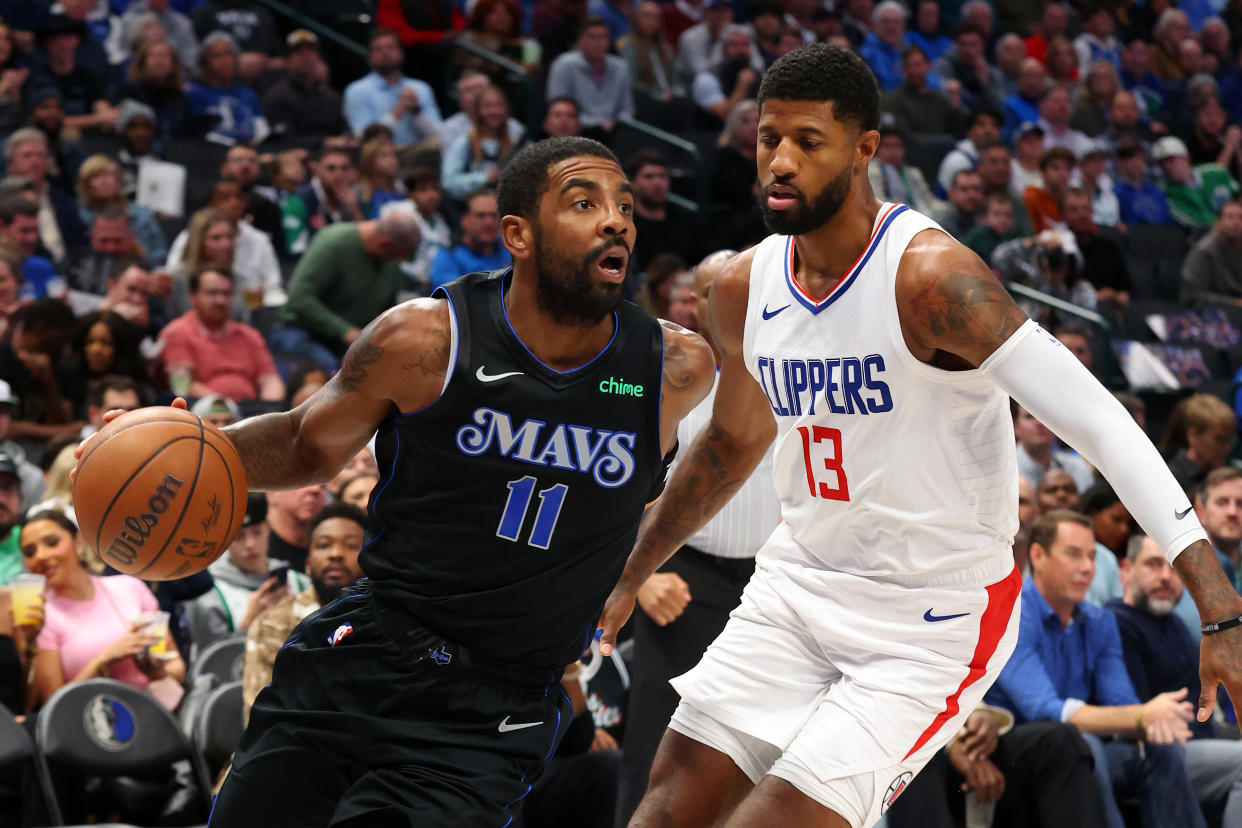 DALLAS, TEXAS - NOVEMBER 10: Kyrie Irving #11 of the Dallas Mavericks drives the ball past Paul George #13 of the LA Clippers in the first half during the NBA In-Season Tournament at American Airlines Center on November 10, 2023 in Dallas, Texas. NOTE TO USER: User expressly acknowledges and agrees that, by downloading and or using this photograph, User is consenting to the terms and conditions of the Getty Images License Agreement. (Photo by Richard Rodriguez/Getty Images)