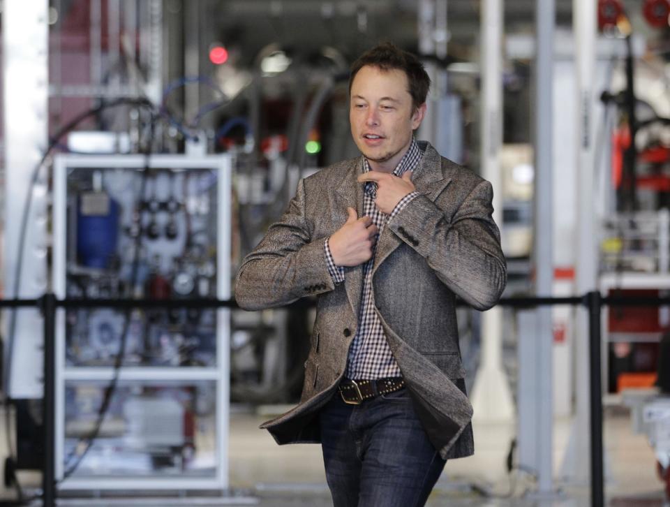 Tesla CEO Elon Musk prepares himself as he walk through the assembly area at the Tesla factory in Fremont, Calif., Friday, June 22, 2012. The first Model S sedan car will be rolling off the assembly line on Friday. (AP Photo/Paul Sakuma)