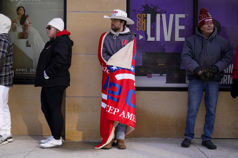 Supporters wait to enter a former President Donald Trump commit to caucus rally, Sunday, Oct. 29, 2023, in Sioux City, Iowa. (AP Photo/Charlie Neibergall)