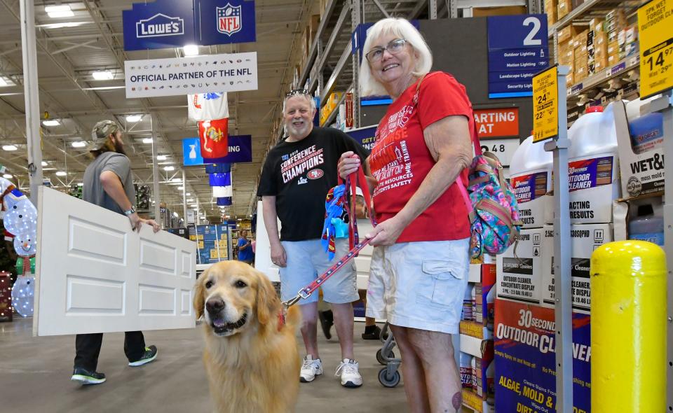 Debbie and Steve Cash and their dog Beau shop for a few items in anticipation of Tropical Storm Ian's rains Sunday morning at Lowe’s in West Melbourne.