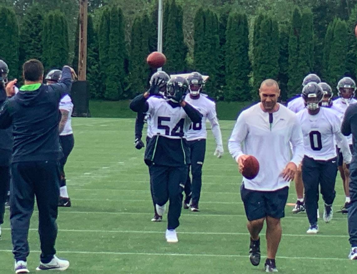 Bobby Wagner (54) and Devin Bush (0), the team’s new inside linebackers for 2023, start drills to begin the Seahawks’ first of nine organized team activities (OTAs) practices Monday, May 22, 2023, at the Virginia Mason Athletic Center in Renton.