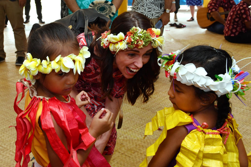 New Zealand's Prime Minister Jacinda Ardern is welcomed by children as she arrives for the Pacific Islands Forum in Funafuti, Tuvalu, Wednesday, August 14, 2019. (AAP Image/Mick Tsikas) NO ARCHIVING