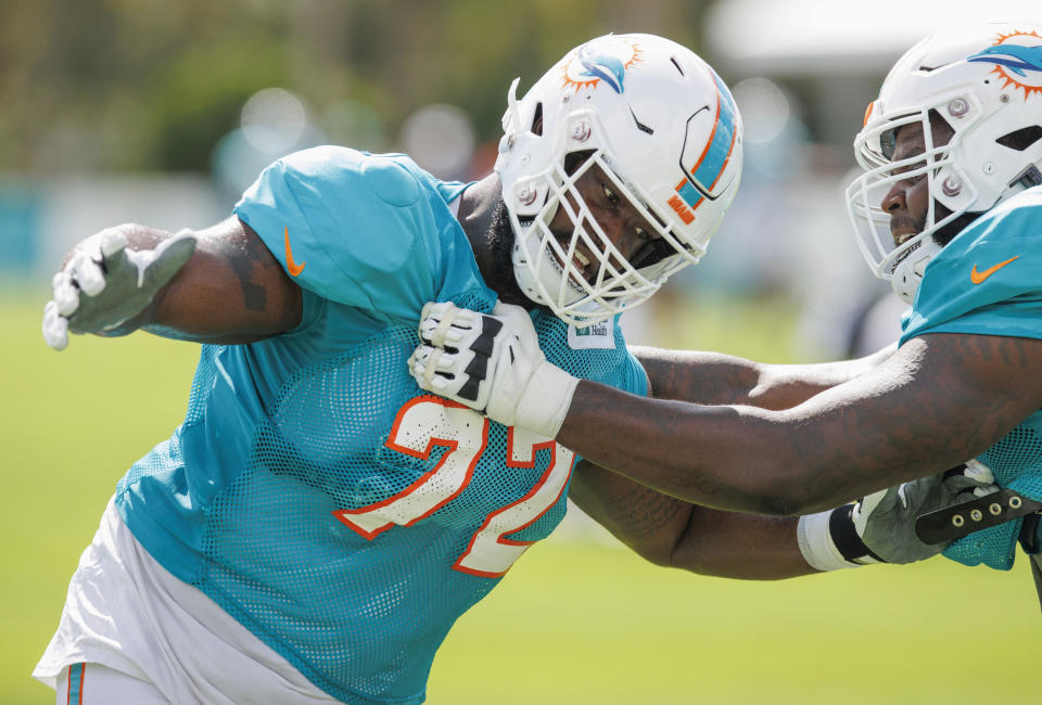 Miami Dolphins offensive tackles Terron Armstead (72) and Greg Little, right, run a drill during an NFL football training camp with the Philadelphia Eagles at Baptist Health Training Complex in Hard Rock Stadium, Wednesday, Aug. 24, 2022, in Miami Gardens, Fla. (David Santiago/Miami Herald via AP)