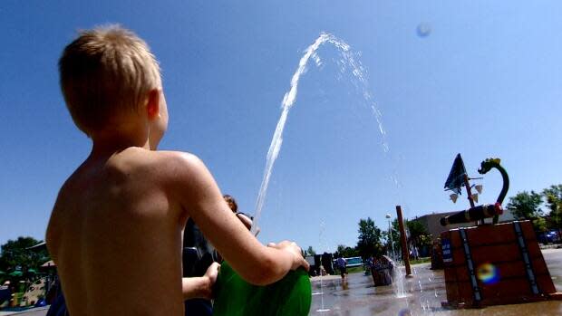 A boy plays at a Regina spray park during a heat wave earlier this summer.  (Germain Wilson/CBC - image credit)