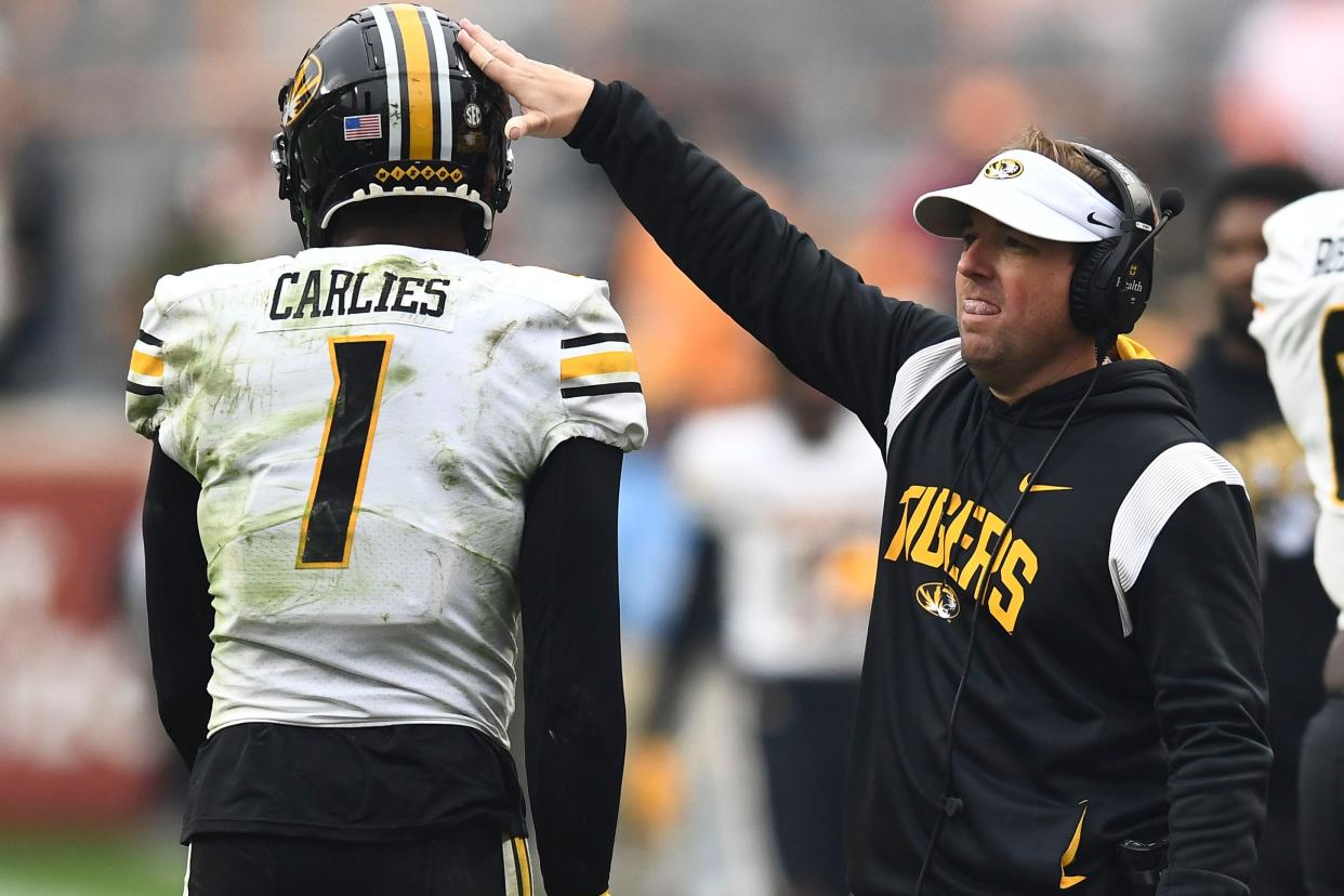 Missouri football coach Eliah Drinkwitz encouraging Jaylon Carlies (1) as he comes off the field during an NCAA college football game against Tennessee on Saturday, November 12, 2022 in Knoxville, Tenn. 