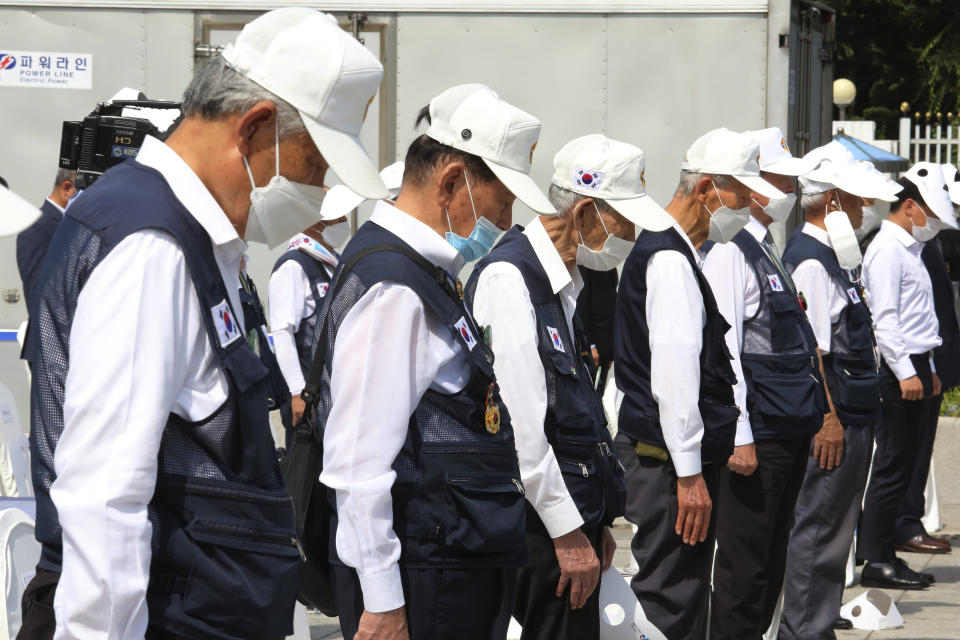 Korean War veterans of South Korea pay a silent tribute during a ceremony to unveil an installation artwork to commemorate the upcoming 70th anniversary of the Korean War, in Seoul, South Korea, Monday, June 15, 2020. South Korea on Sunday convened an emergency security meeting and urged North Korea to uphold reconciliation agreements, hours after the North threatened to demolish a liaison office and take military action against its rival. (AP Photo/Ahn Young-joon)