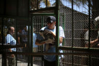 <p>A member of Four Paws International team returns a monkey to its enclosure after receiving treatment at a zoo in Khan Younis in the southern Gaza Strip on June 10, 2016. (REUTERS/Ibraheem Abu Mustafa) </p>