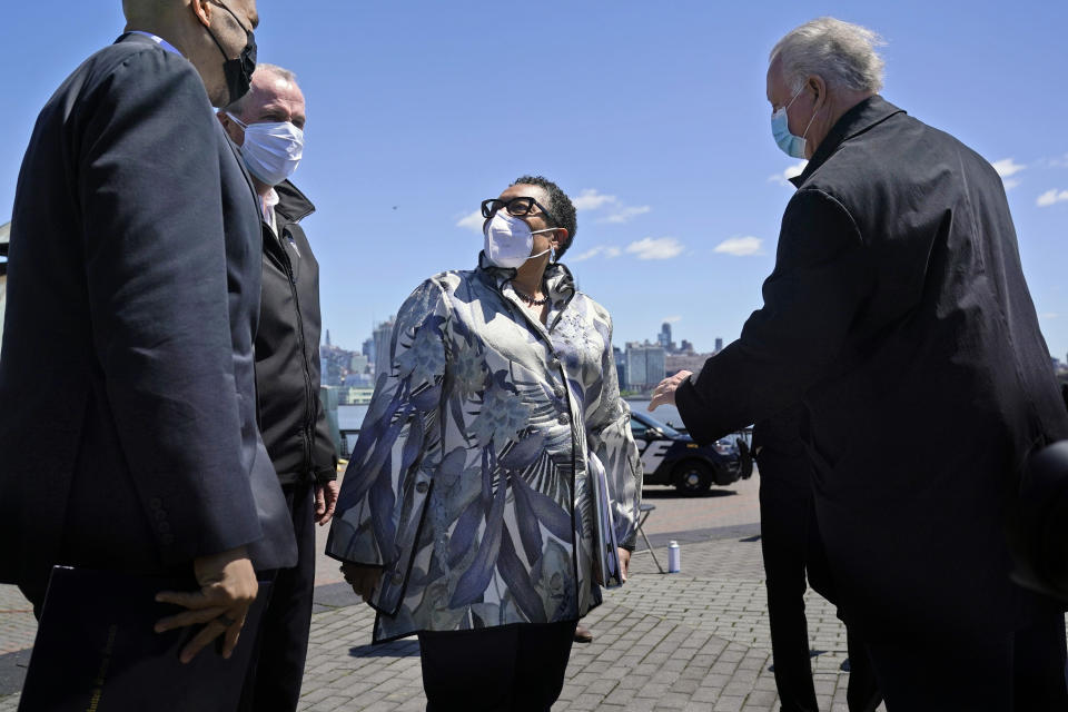 FILE - In this May 6, 2021, file photo Housing and Urban Development Secretary Marcia Fudge, center, speaks with people before a news conference in Hoboken, N.J. More than eight years after Superstorm Sandy overwhelmed the New York City area, Hoboken is breaking ground on a flood resiliency project that is part of a $230 million plan funded by the U.S. Department of Housing and Urban Development. (AP Photo/Seth Wenig, File)