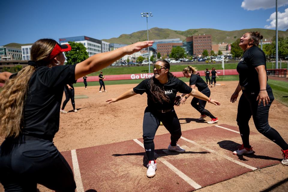 Julia Jimenez, center, crosses home plate during a fun game of “backward softball,” in which players must bat and throw with their weak side and the pattern of bases is reversed, at the start of a Utah softball practice at the Dumke Family Softball Stadium in Salt Lake City on Tuesday, May 16, 2023. | Spenser Heaps, Deseret News