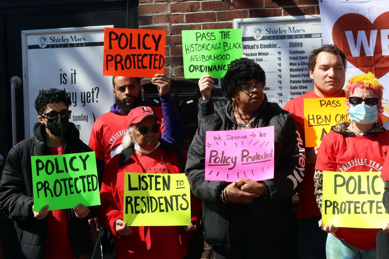 Residents and supporters hold signs at a press conference proposing a Historically Black Neighborhood Ordinance that would stabilize rent and home prices in eight neighborhoods.