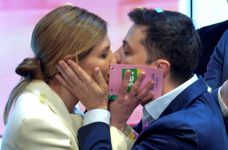 FILE PHOTO: Ukrainian presidential candidate Volodymyr Zelenskiy kisses his wife Olena following the announcement of the first exit poll in a presidential election at their campaign headquarters in Kiev, Ukraine April 21, 2019. REUTERS/Oleksandr Klymenko/File Photo