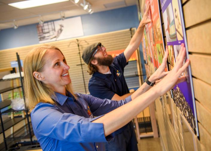 Heather Ray and Ken Keffer hang signage on Tuesday, May 17, 2022, as they prepare to open their new store, Wild Birds Unlimited, next month.