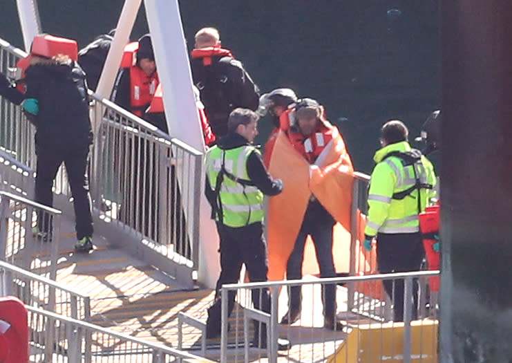 Men thought to be migrants are met by Border Force officers in Dover, Kent, after small boat incidents in The Channel earlier this morning. (Photo by Gareth Fuller/PA Images via Getty Images)