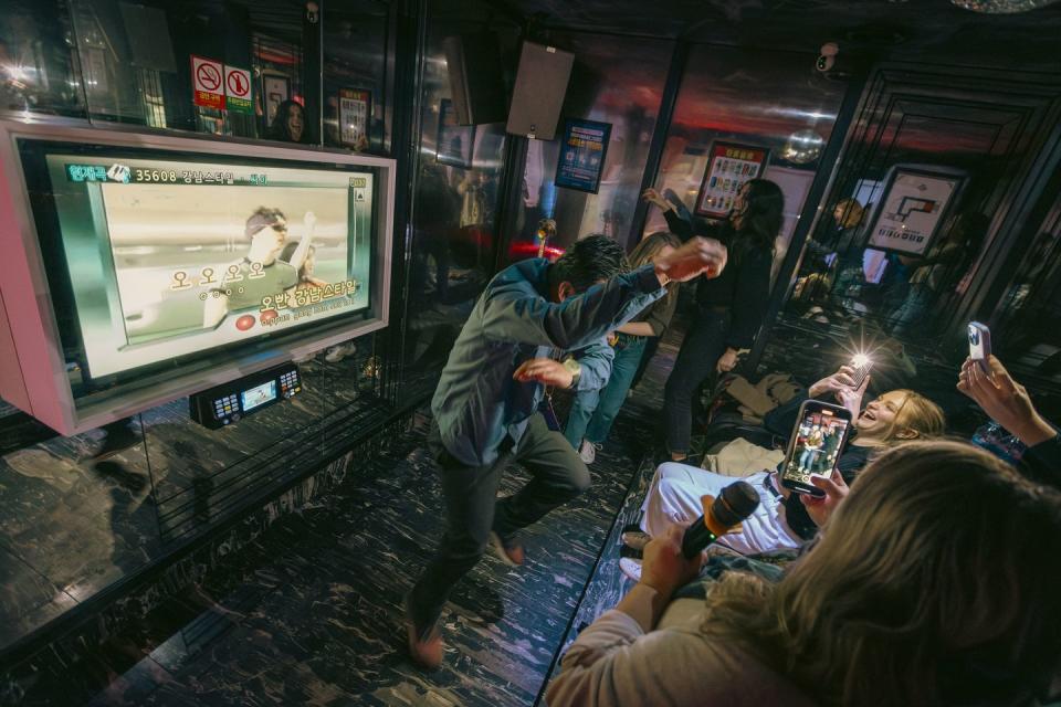 a group of people having fun in a private karaoke booth