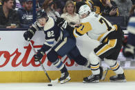 Pittsburgh Penguins forward Evgeni Malkin (71) checks Columbus Blue Jackets forward Mikael Pyyhtia (82) during the second period of an NHL hockey game in Columbus, Ohio, Saturday, March 30, 2024. (AP Photo/Paul Vernon)