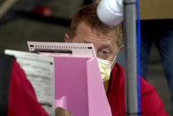 Maricopa County ballots cast in the 2020 general election are examined and recounted by contractors working for Florida-based company, Cyber Ninjas, Thursday, May 6, 2021 at Veterans Memorial Coliseum in Phoenix. The audit, ordered by the Arizona Senate, has the U.S. Department of Justice saying it is concerned about ballot security and potential voter intimidation arising from the unprecedented private recount of the 2020 presidential election results. (AP Photo/Matt York, Pool)