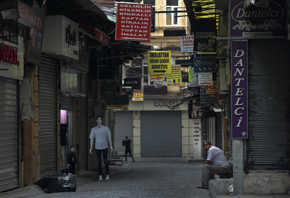 A vendor waits for customers in Eminonu market, an area usually packed with shop goers, but currently nearly deserted due to the strict lockdown to help curb the spread of the coronavirus, in Istanbul, Saturday, May 8, 2021. The "full lockdown," which began in late April and will last until May 17 came amid a huge surge in infections. (AP Photo/Emrah Gurel)