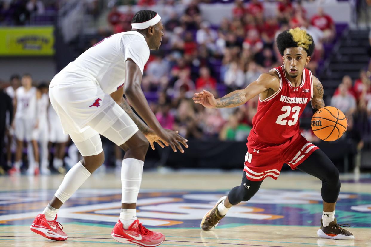 Wisconsin Badgers guard Chucky Hepburn (23) controls the ball against the Southern Methodist Mustangs in the second half during the Fort Myers Tip-Off championship game at Suncoast Credit Union Arena on Nov. 22, 2023.