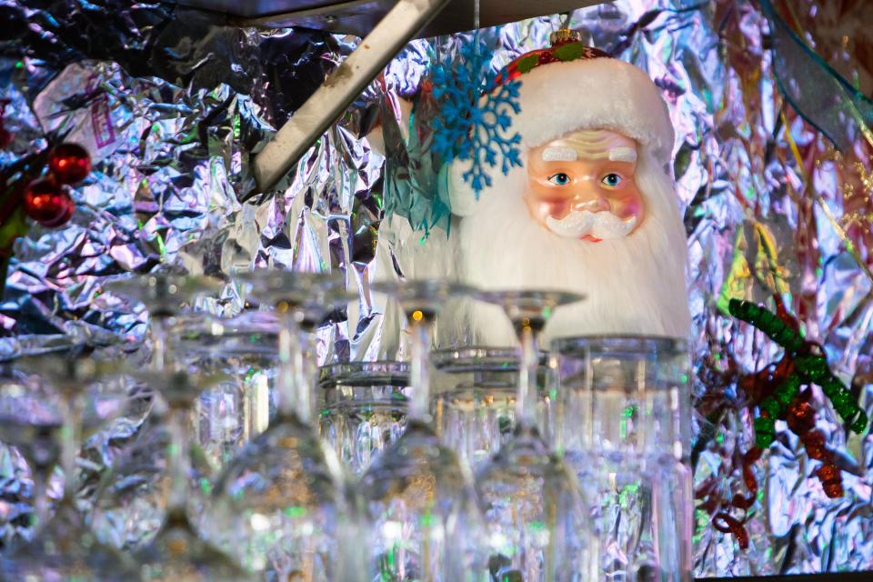 Santa Clause ornament hangs next to glassware at Salt and Lime after decorations transform it into the Feliz Navidad Cantina for the holidays on Nov. 29, 2021, in Scottsdale.