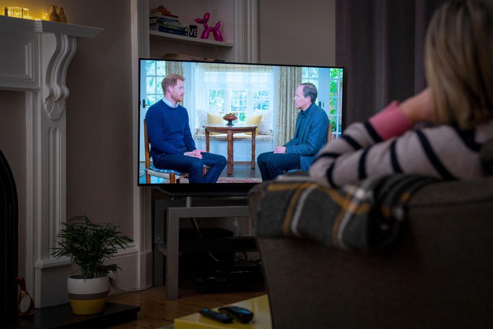 A person at home in Edinburgh watching the Duke of Sussex being interviewed by ITV's Tom Bradby during Harry: The Interview, two days before his controversial autobiography Spare is published. Picture date: Sunday January 8, 2023.