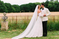 <p>The former ‘Made In Chelsea’ star wore a bespoke Halfpenny London dress for her wedding to Hugo Taylor. Made from French lace, spotty tulle and silk organza, the gown boasted double bubble sleeves and a long, plain veil. <em>[Photo: Instagram/Millie Mackintosh]</em> </p>