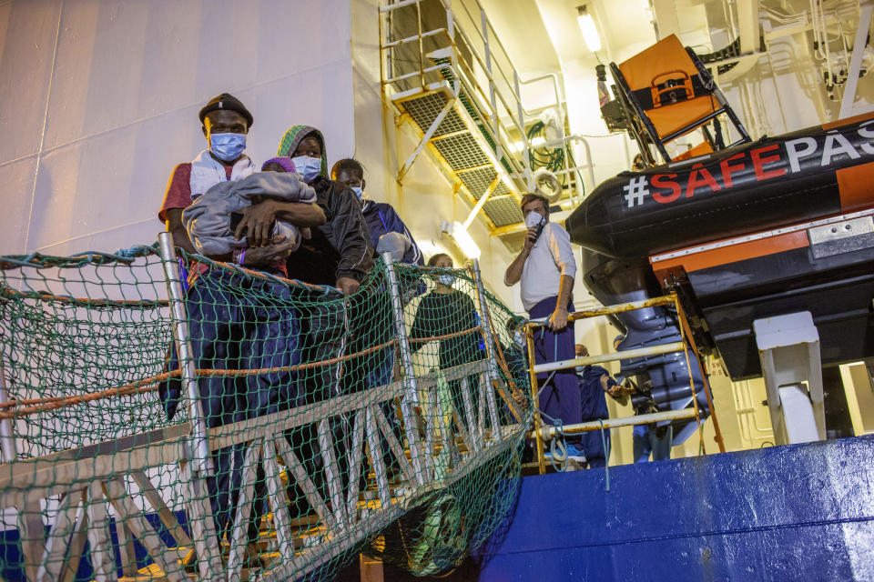 FILE - Migrants disembark from the Norway-flagged Geo Barents rescue ship carrying 572 migrants, in Catania's port, Sicily, southern Italy, Sunday, Oct. 6, 2022. Italy's new government has blocked humanitarian rescue ships from accessing its ports, resulting in a stand-off with charities that patrol the deadly central Mediterranean Sea smuggling routes, used by people desperate to reach Europe for a new life. (AP Photo/Massimno Di Nonno, file)